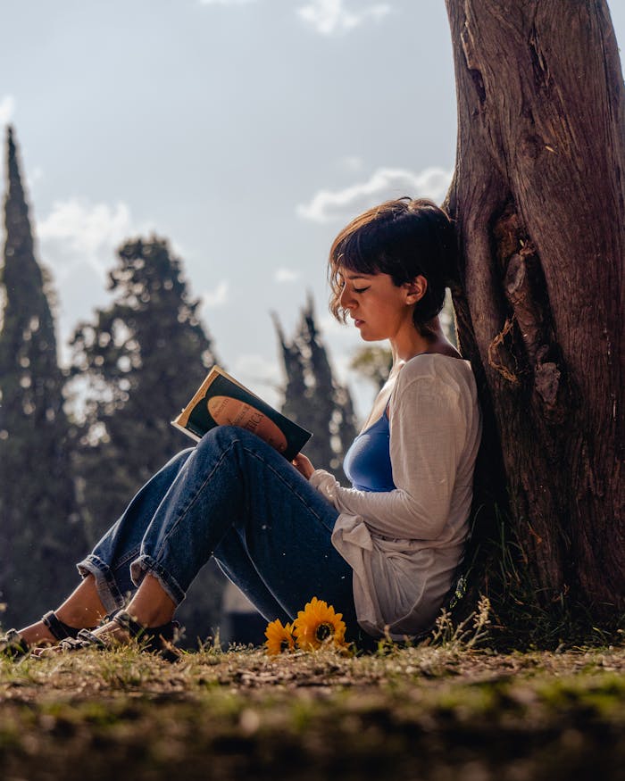 Woman with Book by Tree